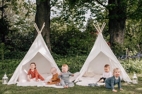 Babies in merino pyjamas playing outside