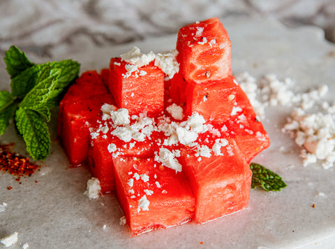 cubed watermelon seasoned with cheese and lime