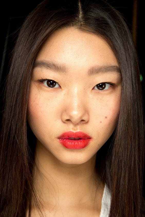 up close of a girls face with red lipstick