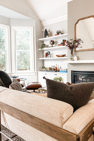 Living room with neutral colors and wood elements.