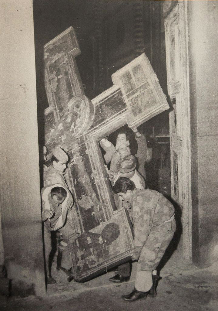 Soldiers rescue a Crucifixion by Cimabue during the November 1966 flood of the Arno River, Florence; they were nicknamed the 'mud angels' for their work carrying the cross and collecting specks of gold leaf and paint from the flooded streets.