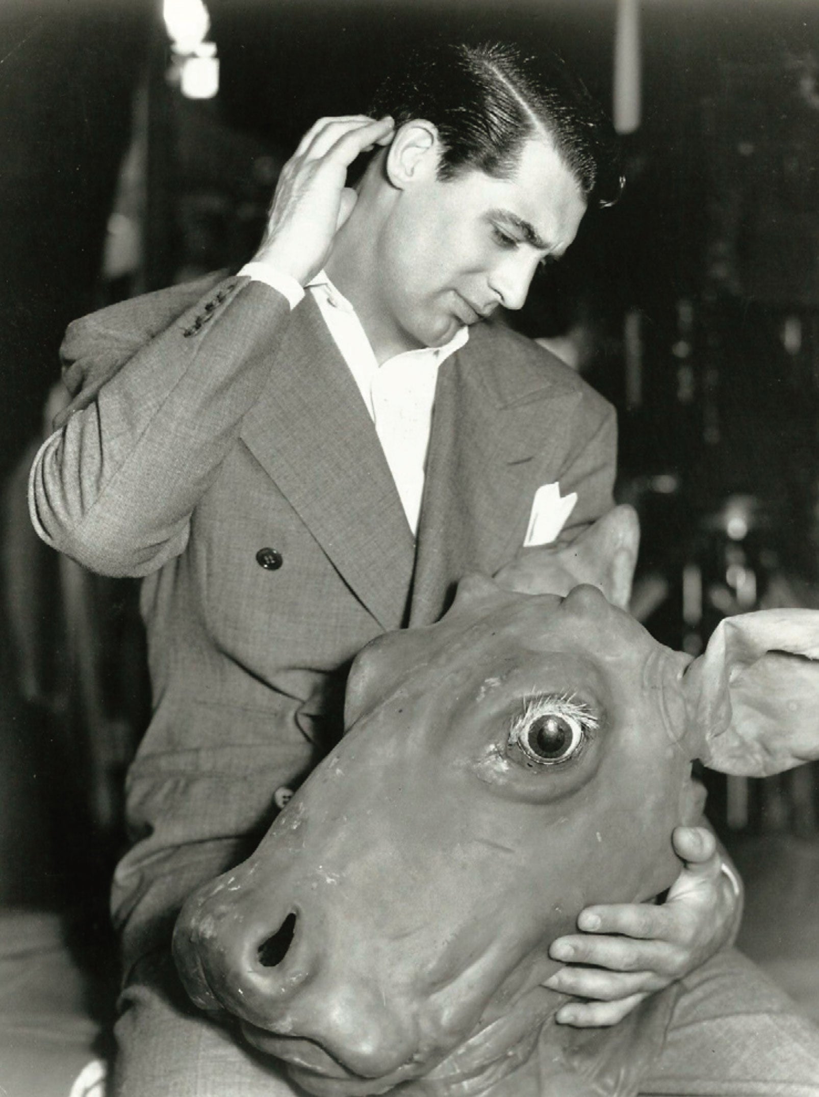 Cary Grant nurses his 1933 Mock Turtle mask