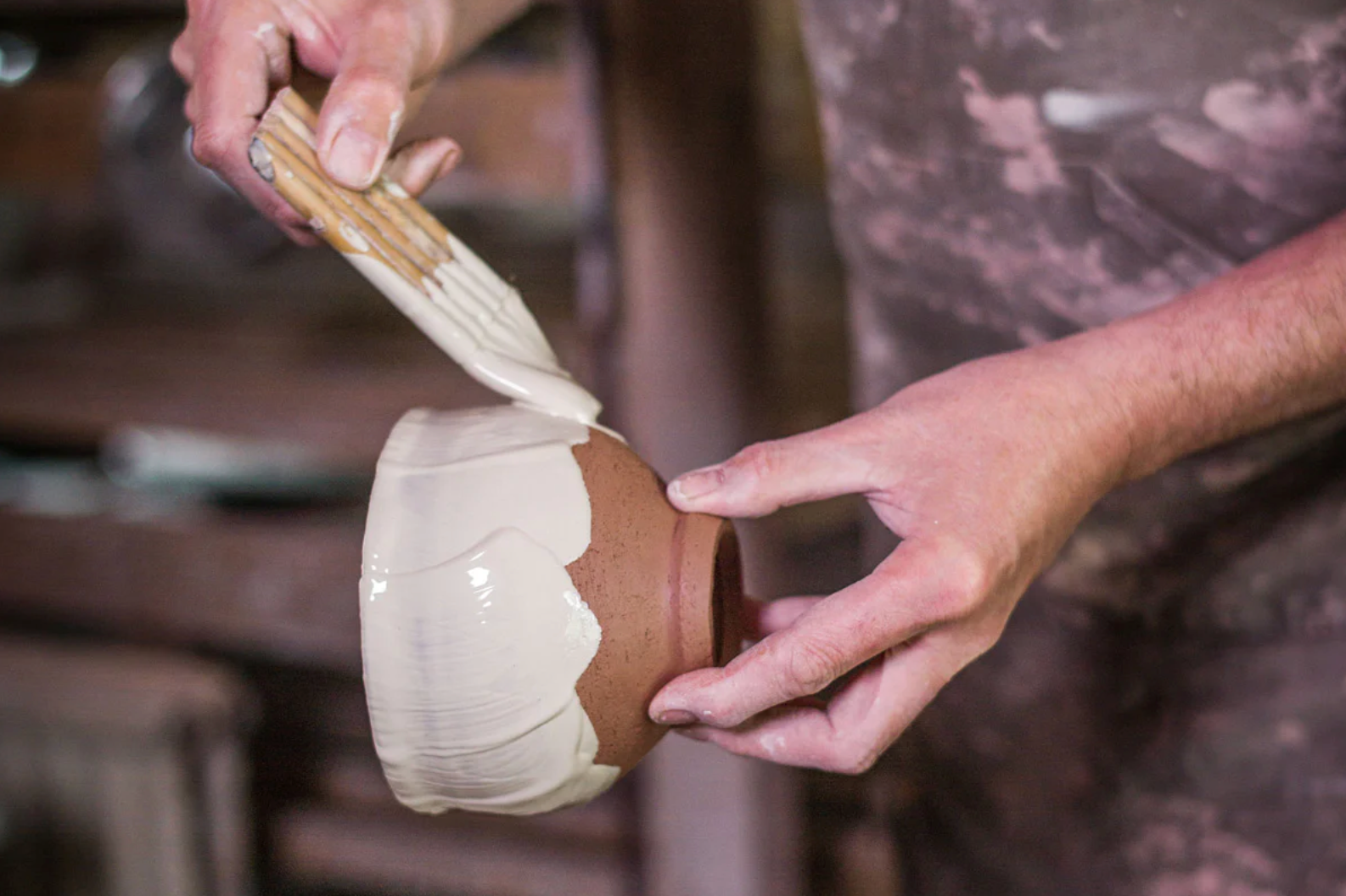 Phil applies glaze to a chawan with a handmade brush