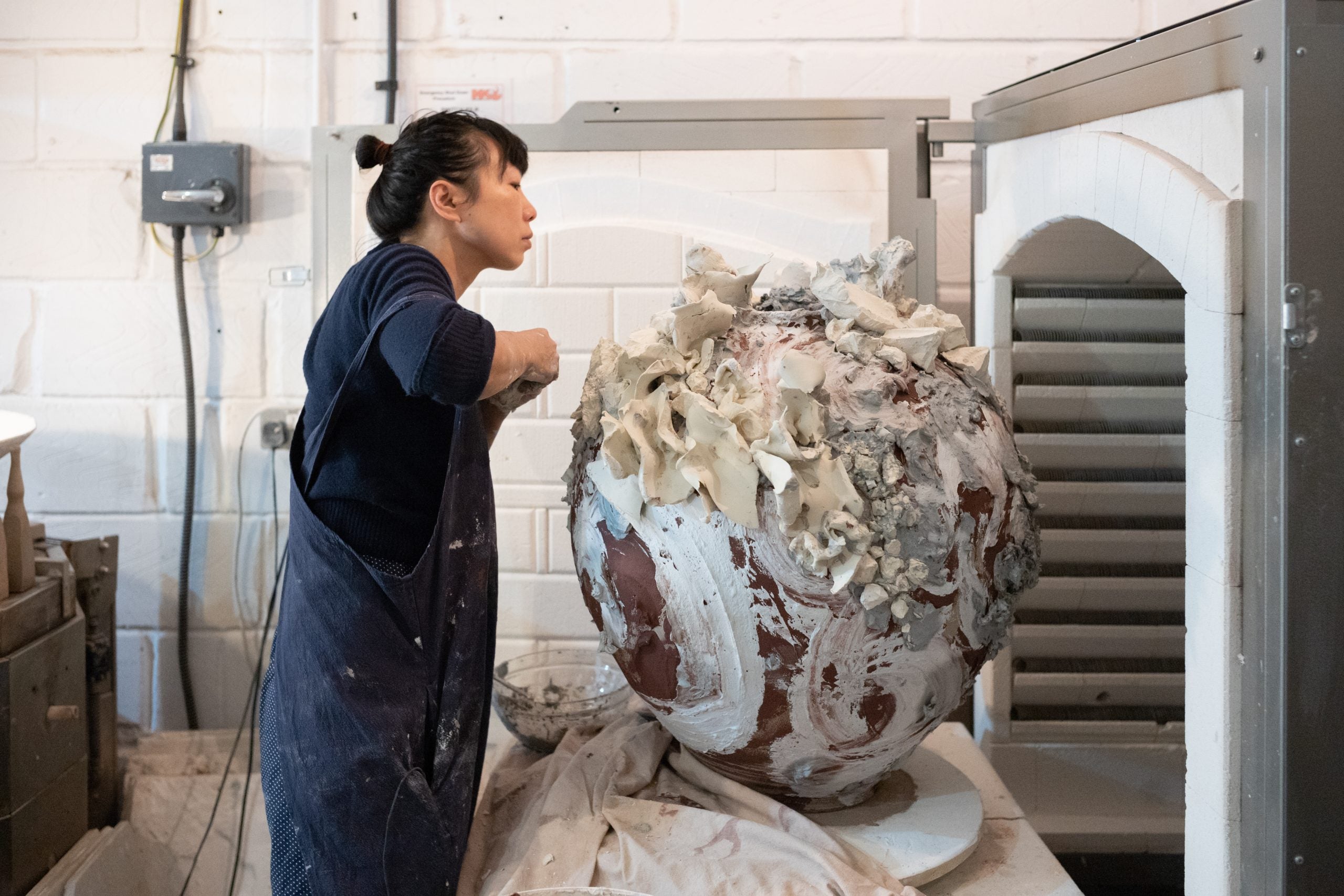 Akiko Hirai adding the finishing touches to one of her Large Moon Jars, photo Jay Goldmark