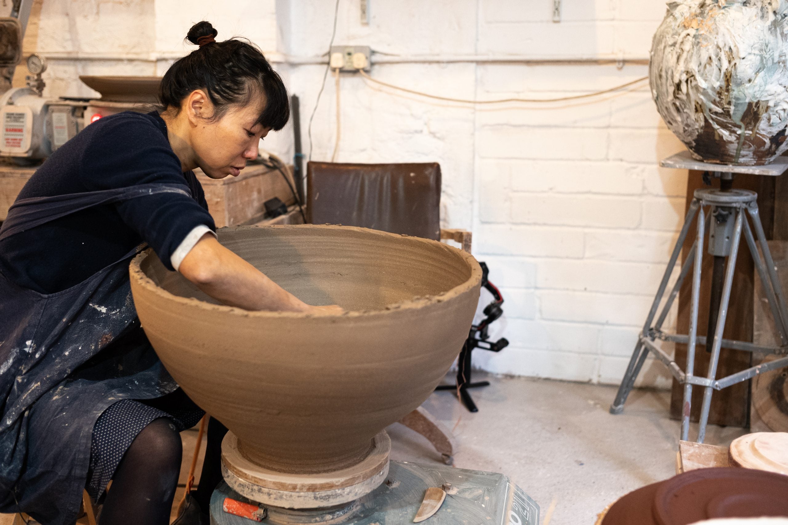 Akiko Hirai throwing the bottom half of one of her iconic Large Moon Jars photographed by Jay Goldmark in her studio