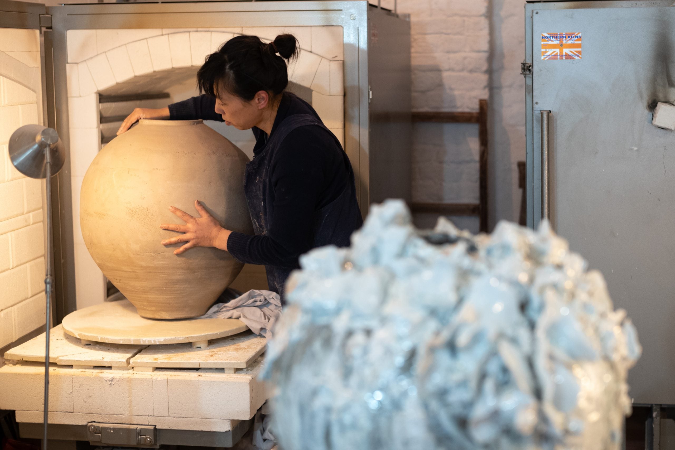 Akiko Hirai preparing one of her Large Moon Jars for the kiln, photographed by Jay Goldmark in her studio