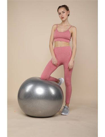 a woman posing in front of an onamaste gymball
