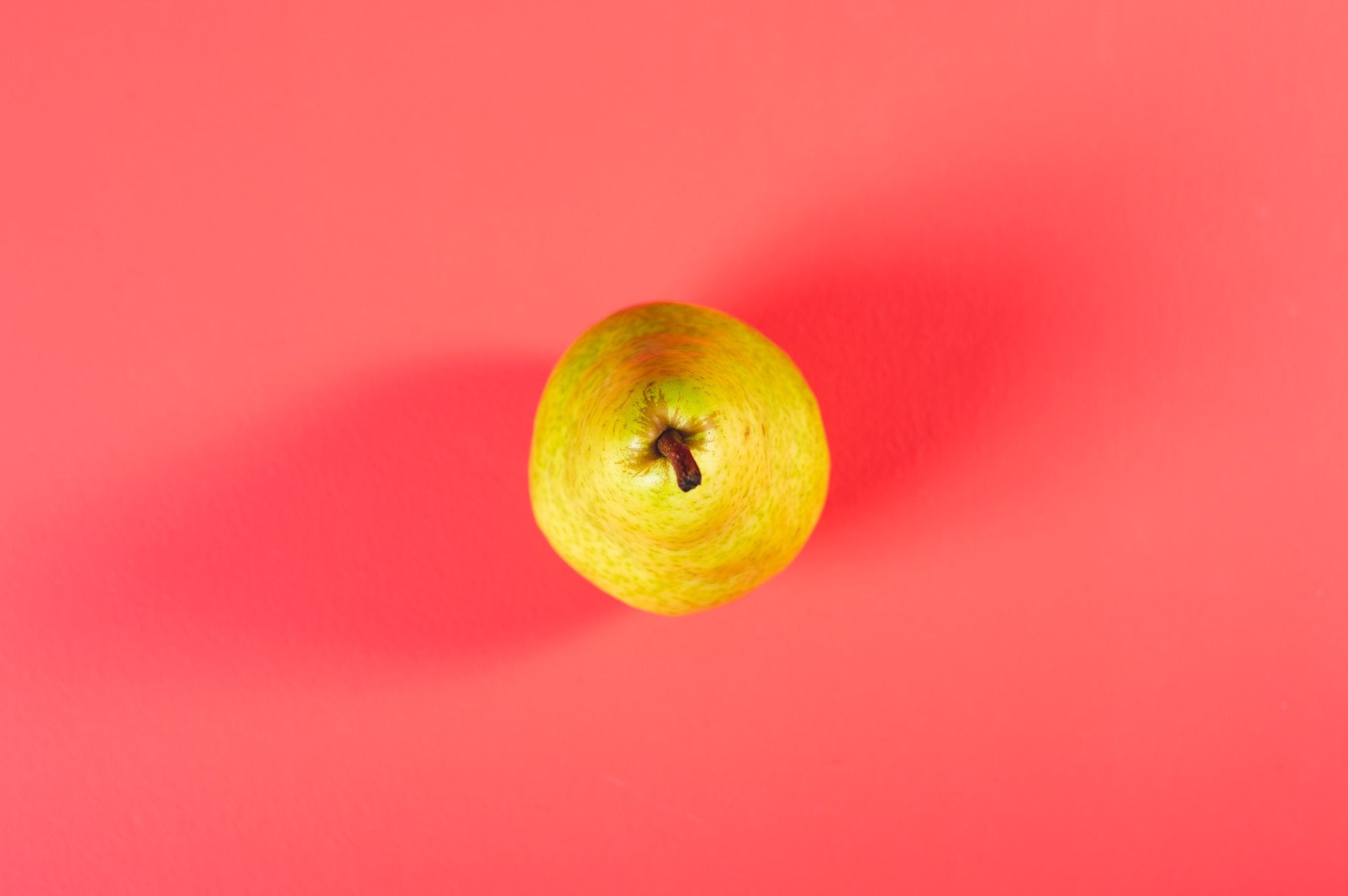 Pear on pink floor