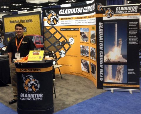 NTEA Work Truck Show- Gladiator Cargo Net Debut. Posters and man at booth
