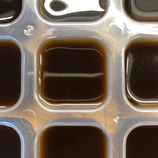 ice cube tray containing coffee