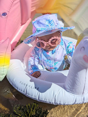 baby sun protective swimsuit on unicorn print with matching beach bucket hat