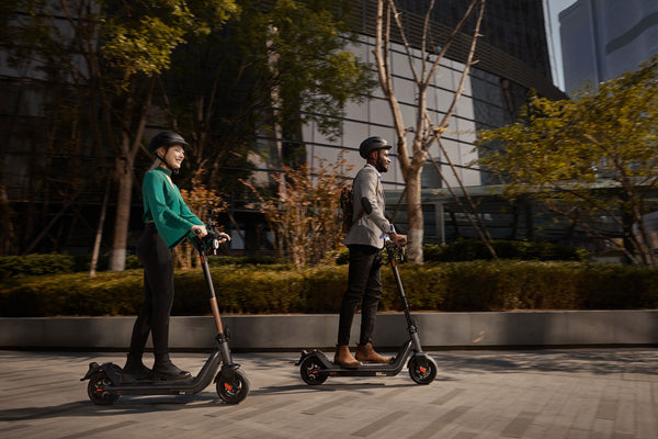 Two riders on a NIU KQi3 Pro kick scooter