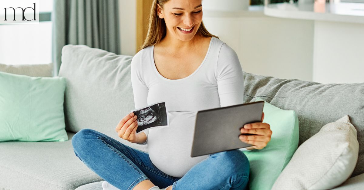 pregnant women sitting on the couch 