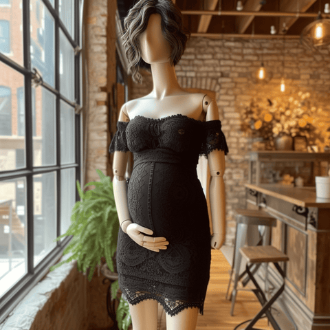 Pregnant wooden mannequin wearing sexy black off-the-shoulder maternity dress