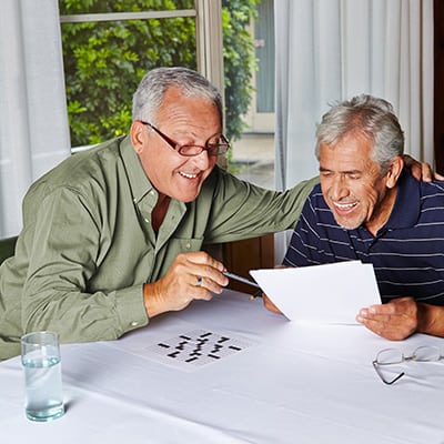 Elderly men solving a puzzle or memory game