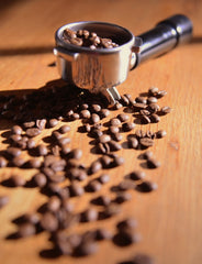 espresso coffee beans in and around grinder