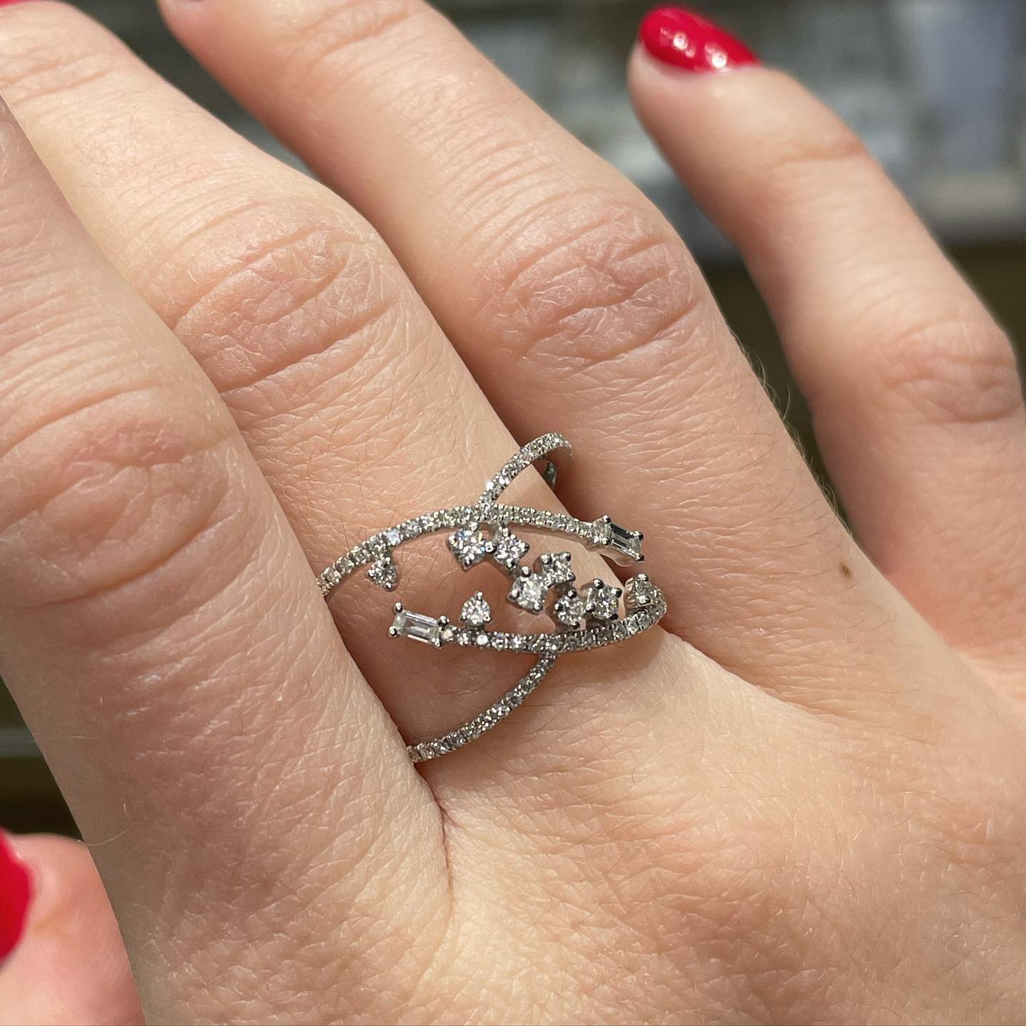 Silver diamond ring on a finger