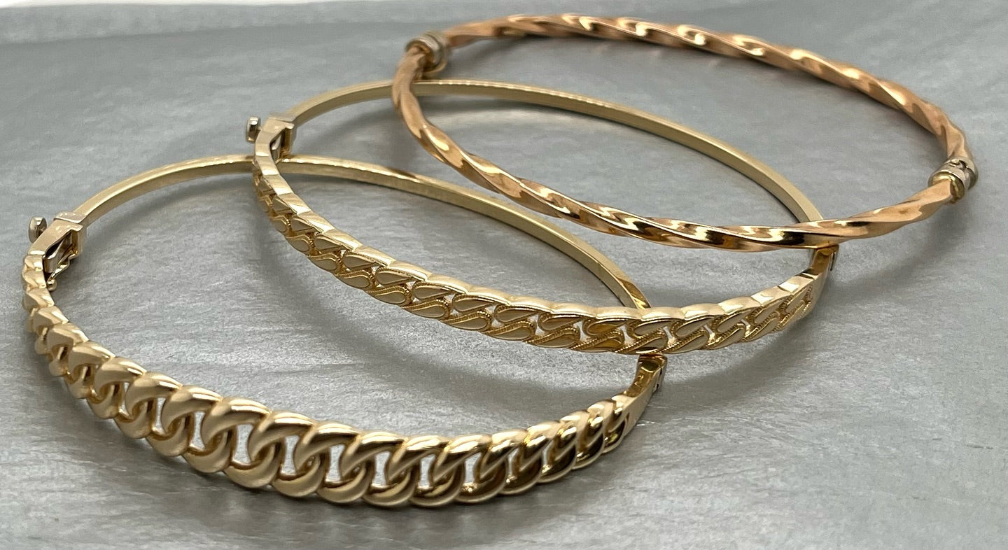 Gold bangles sitting on a table