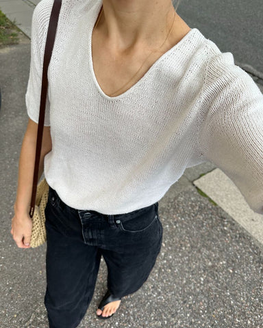 Woman wearing a white hand knitted t shirt