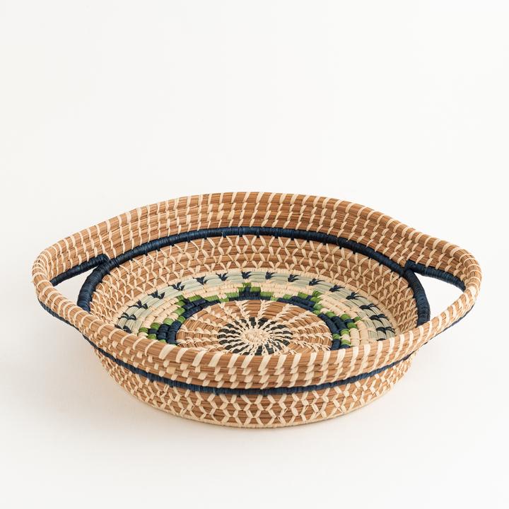 Round pine needle basket with handles in dyed and undyed raffia