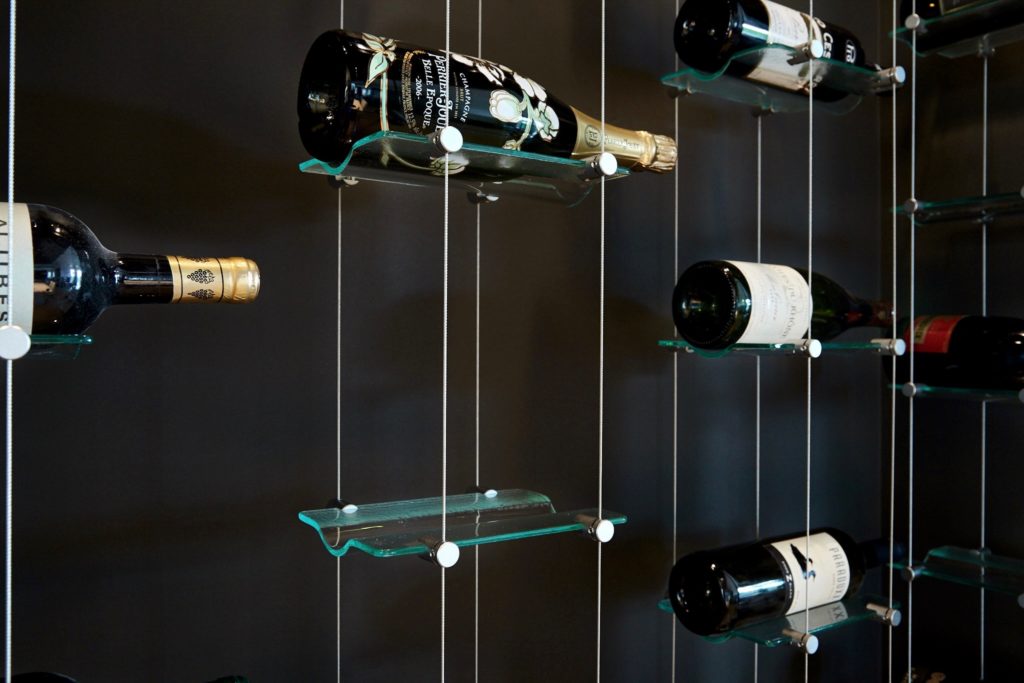 The minimalist will love this contemporary cable and glass wine racking system floating in the air.