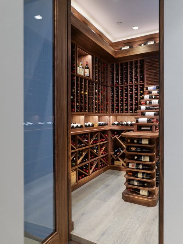 photo of the entrance of a basement wine cellar with traditional wood wine racks