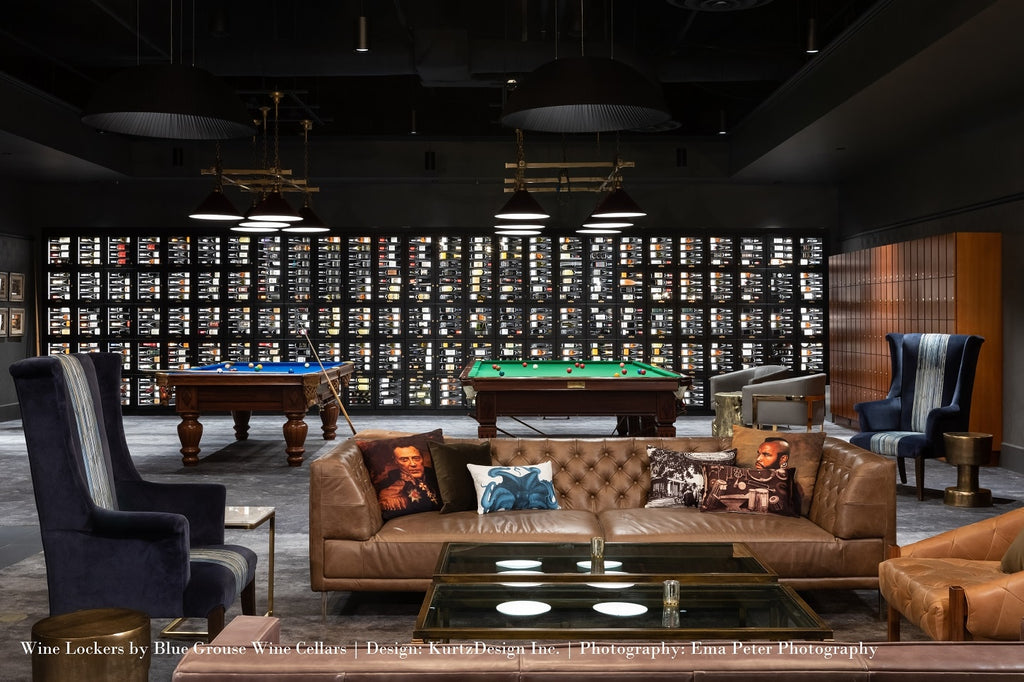 Wine wall at the back of the room with pool table and sitting area in the foreground.