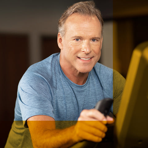 man smiling on exercise bike