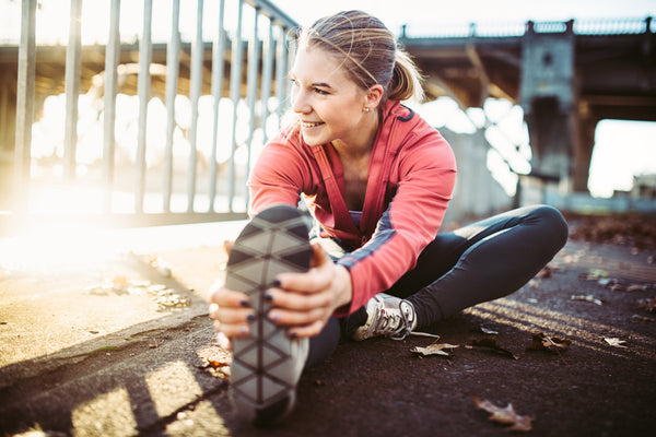 woman smiling and stretching