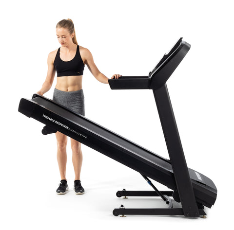 woman with low-end folding treadmill