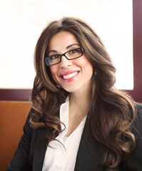 brunette woman in glasses smiling