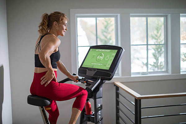 woman on upright cycle