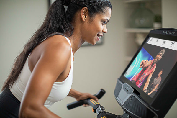 woman riding a cycle with a large touchscreen