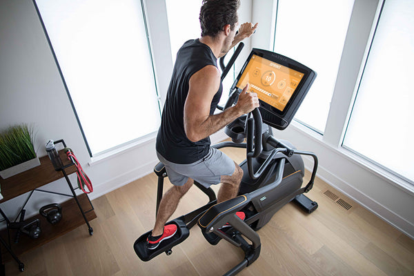 man on elliptical working out