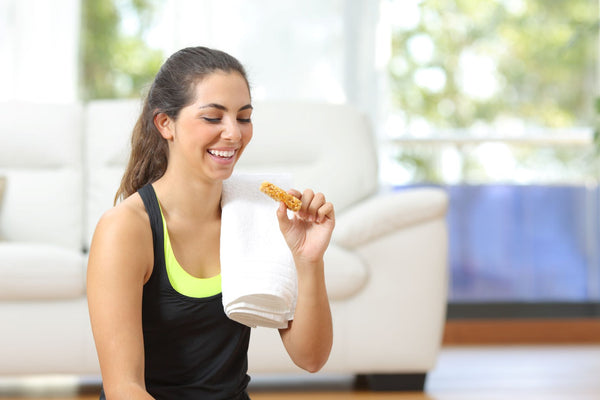 woman smiling holding cookie