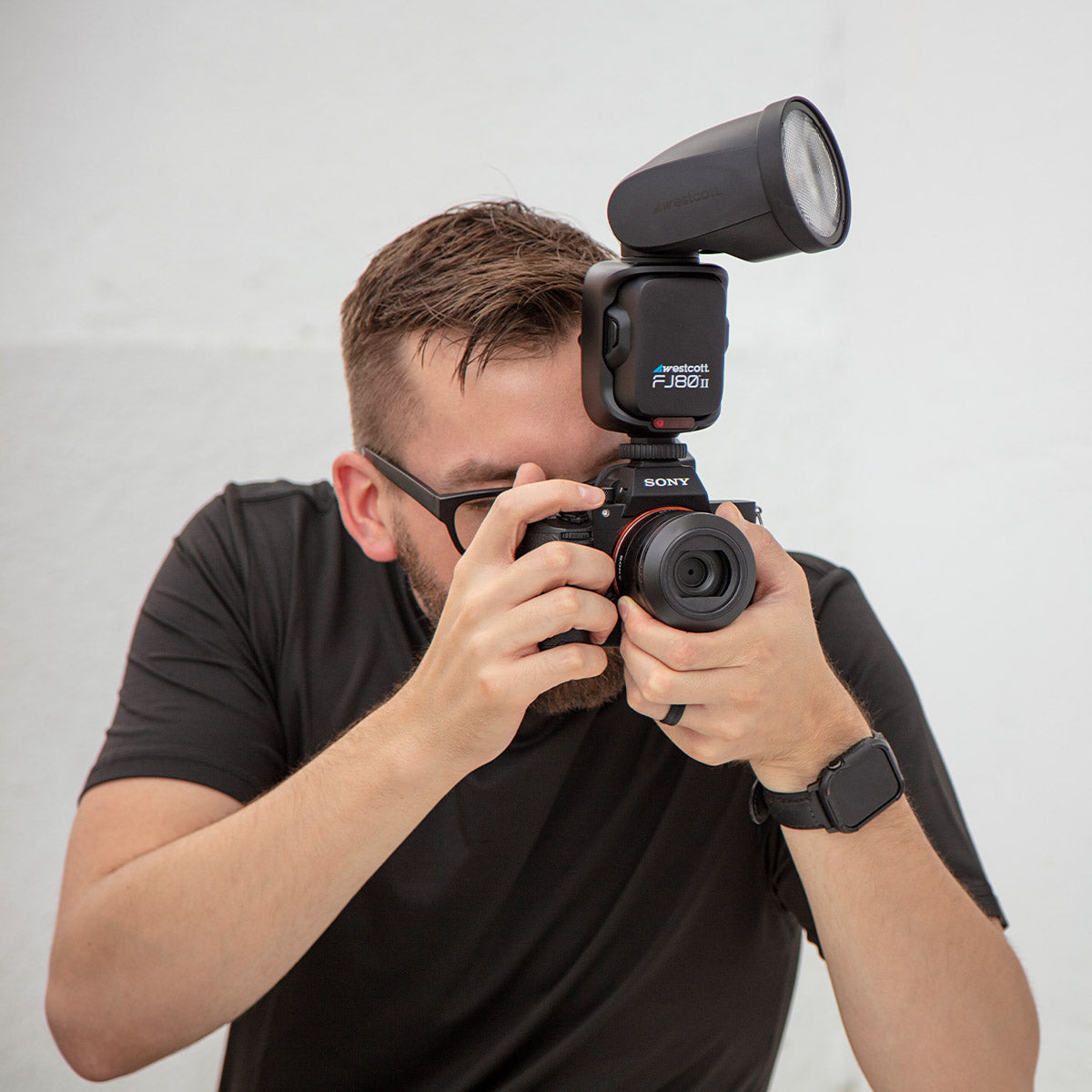 A cameraman using the Westcott FJ80 II on a Sony Camera