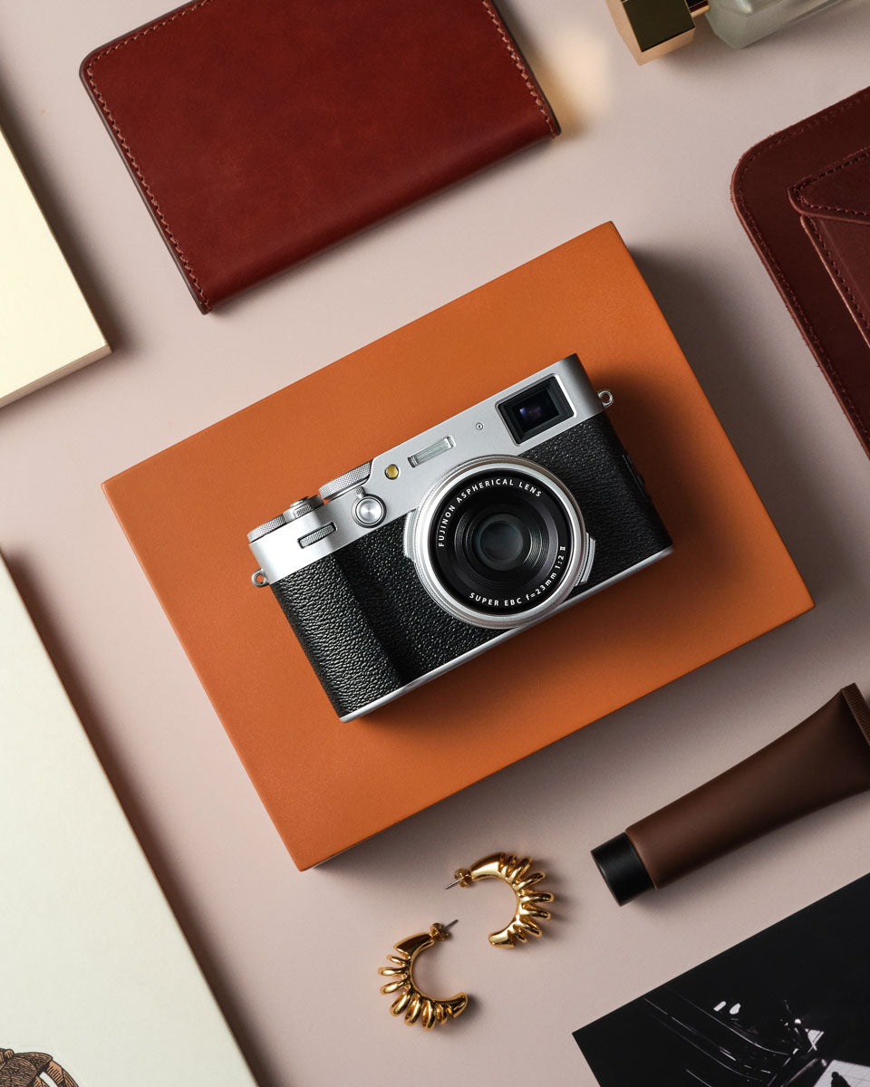 Silver version of the camera sitting on an organised desk