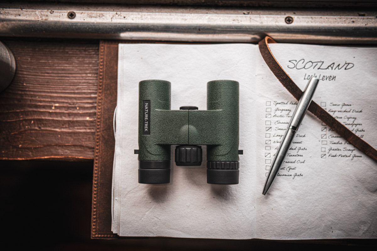 Lifestyle photo of the binoculars on a desk