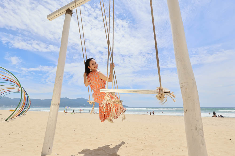 Sample photo of a lady at the beach on a swing