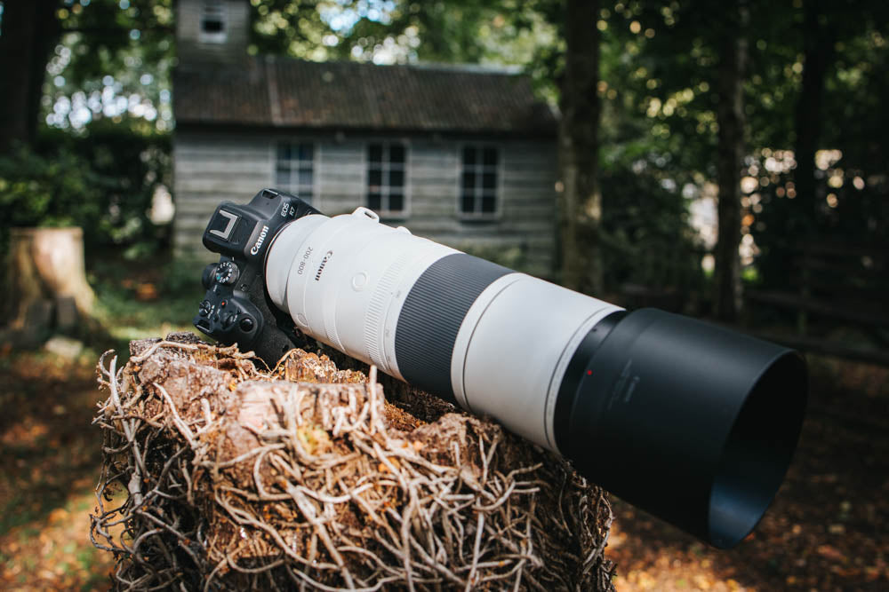 Photo of the lens next to an abandoned house