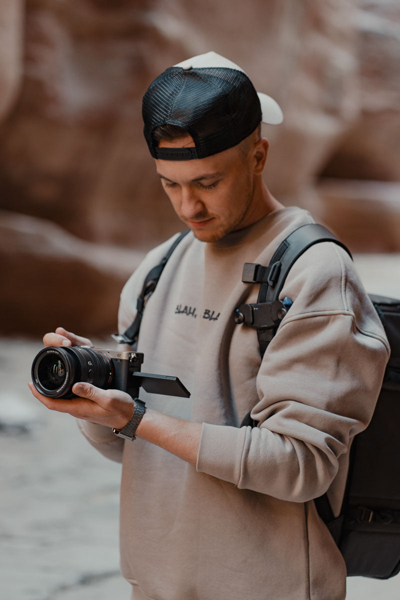 Photographer in the desert holding the camera body