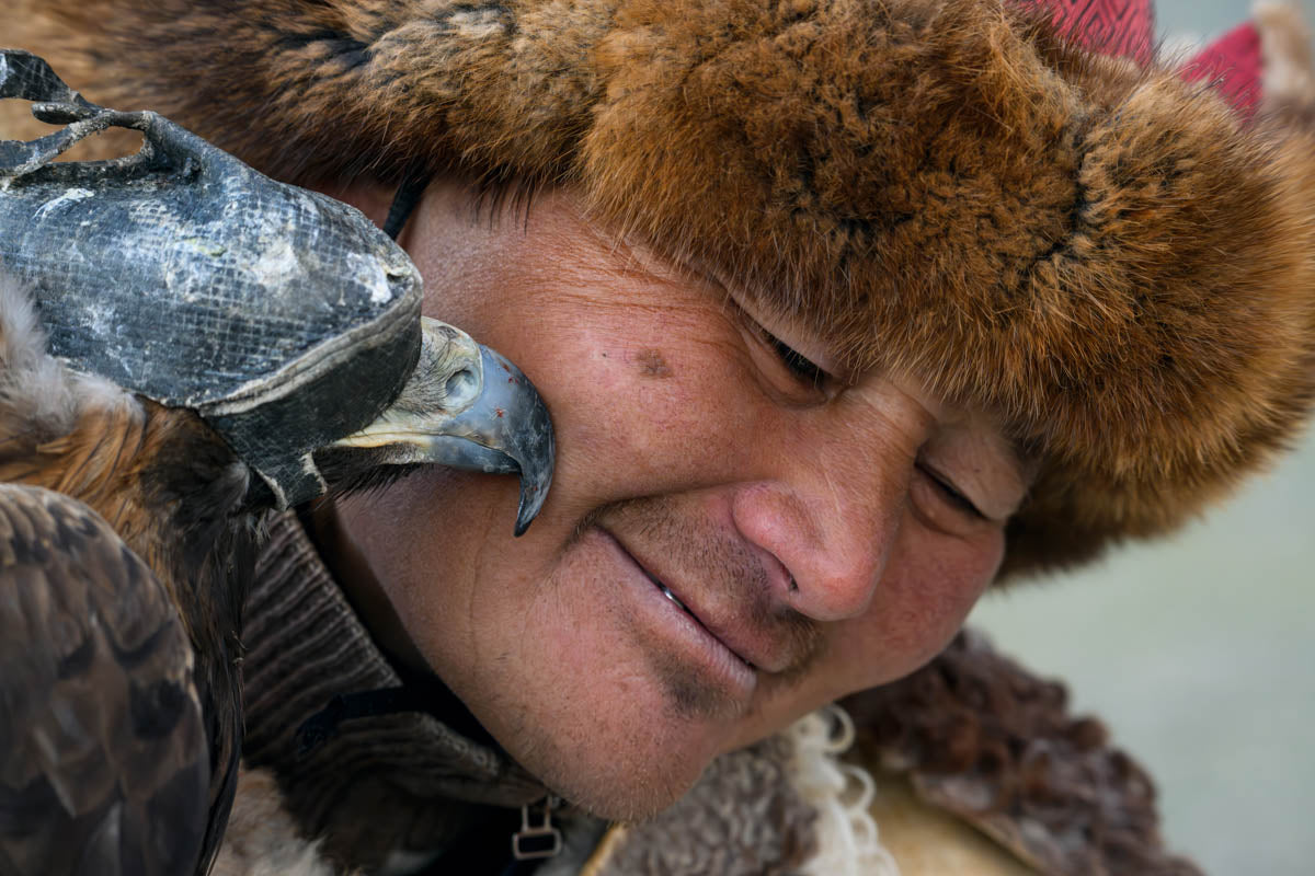 Traditional hunter with bird of prey