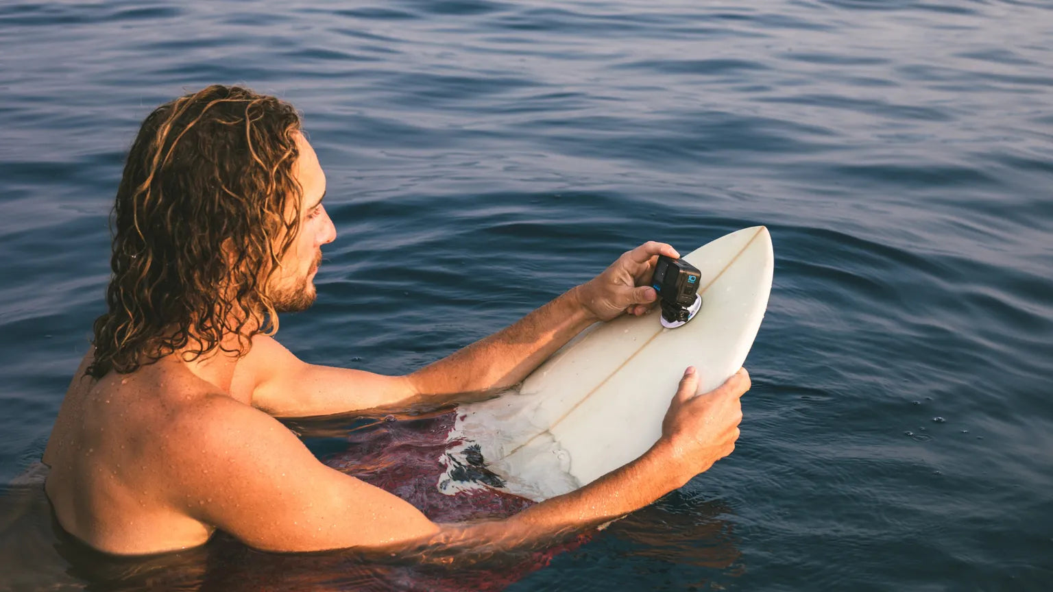 Photo of a surfer with the GoPro mounted to his board
