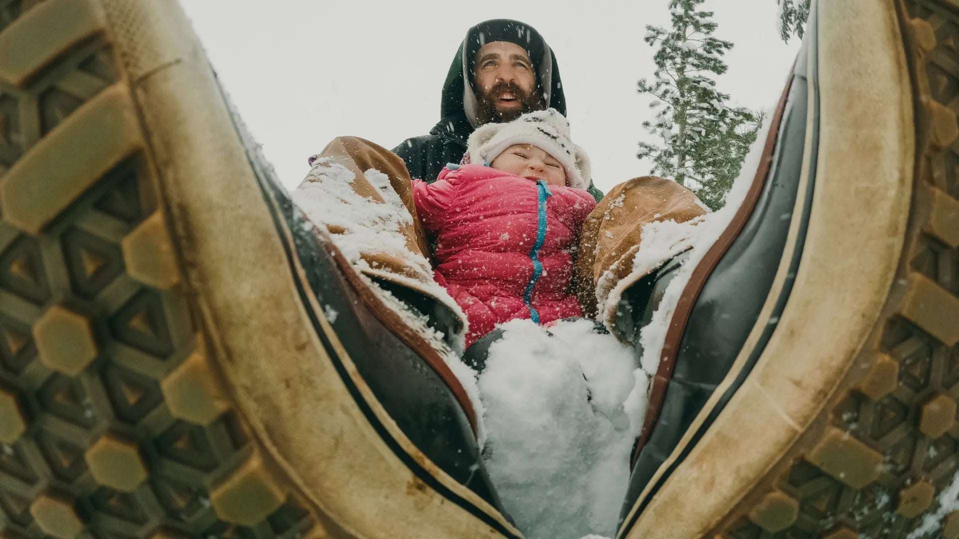 Photo of a father and son playing in the snow