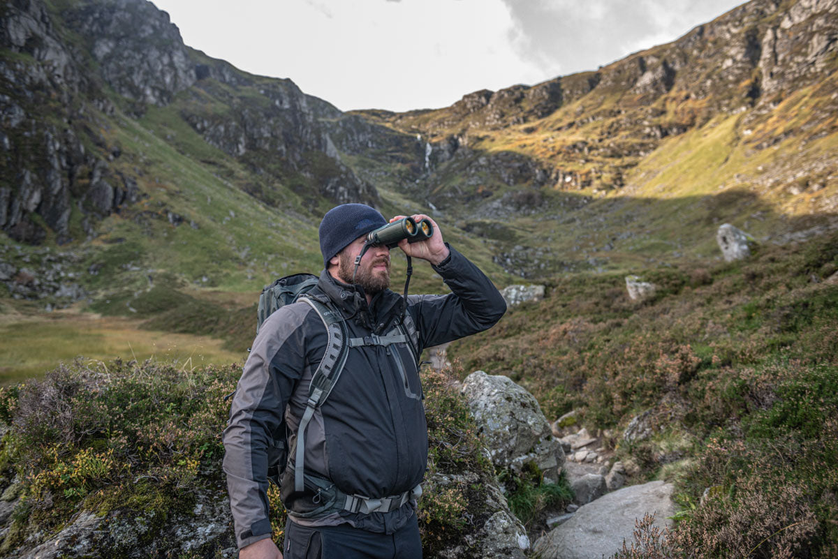 Lifestyle photo of the hiker using the binoculars