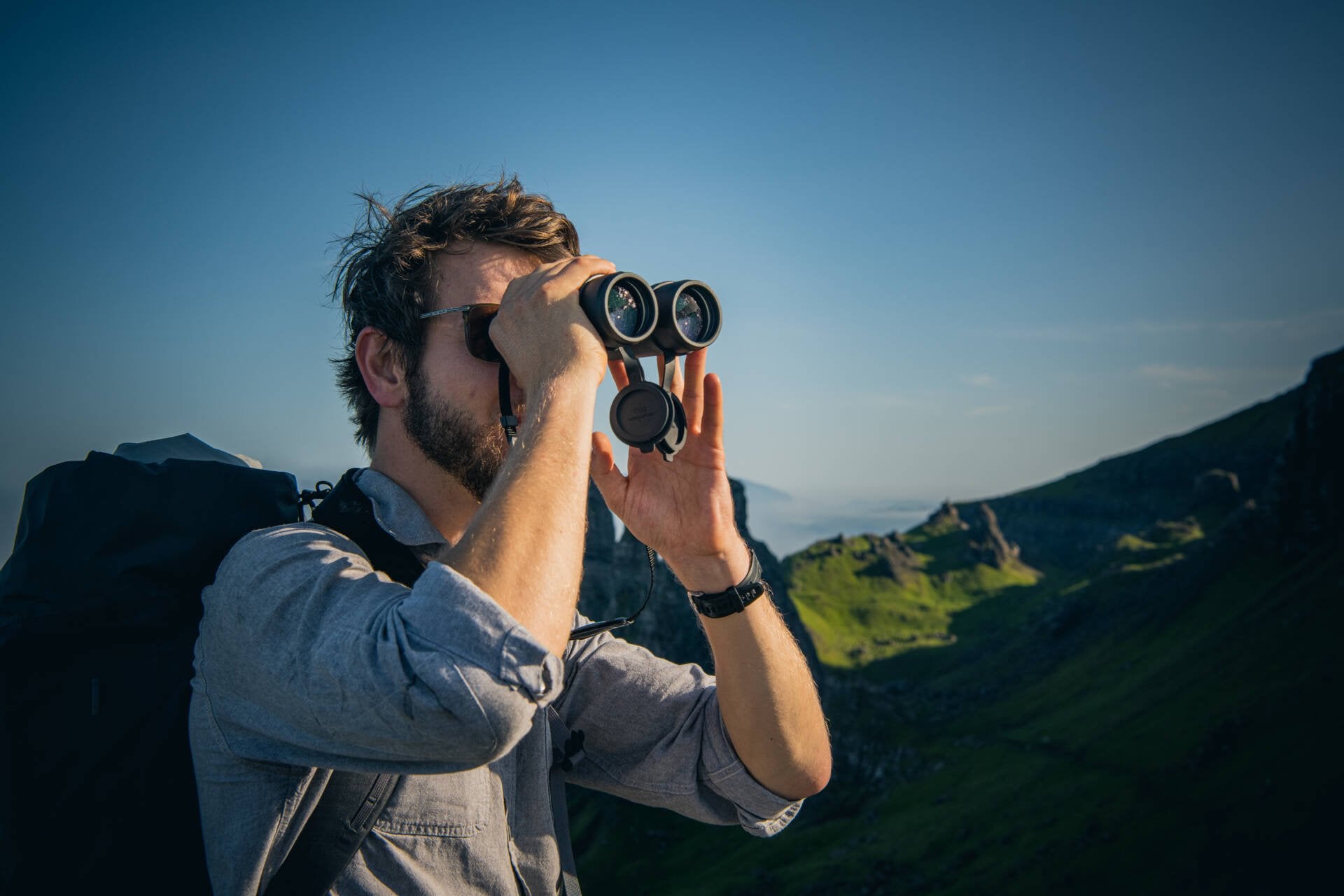 Lifestyle photo of the Nikon Monarch M7 binoculars in use by a hiker in the mountains