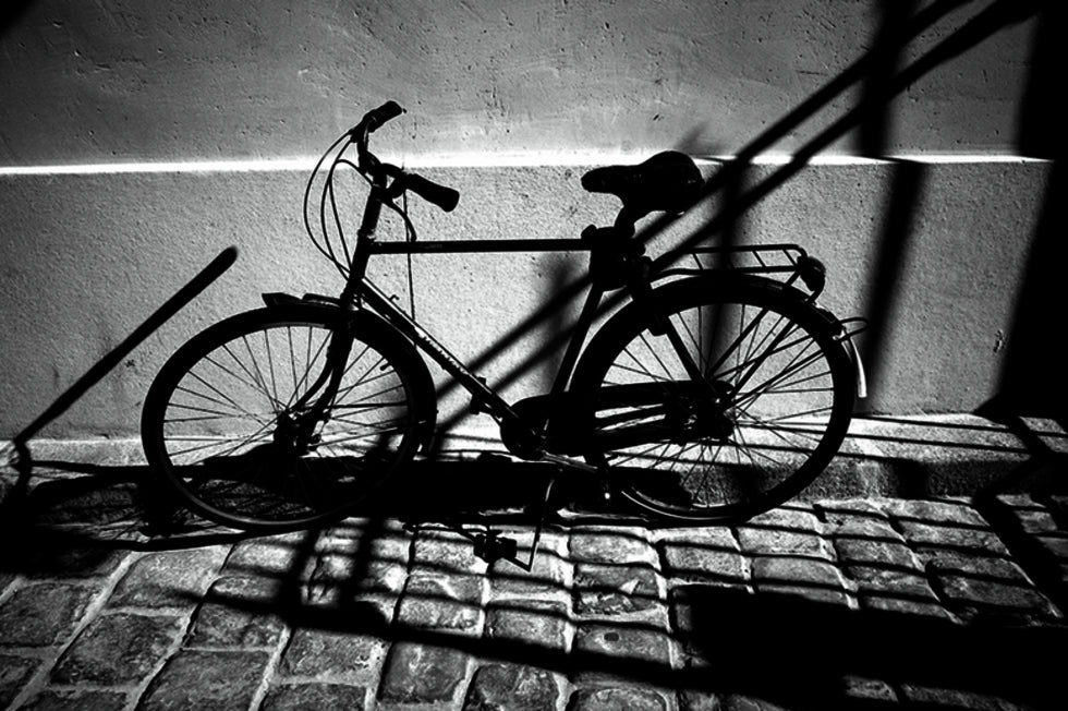 Photo of a bicycle in the street in black and white