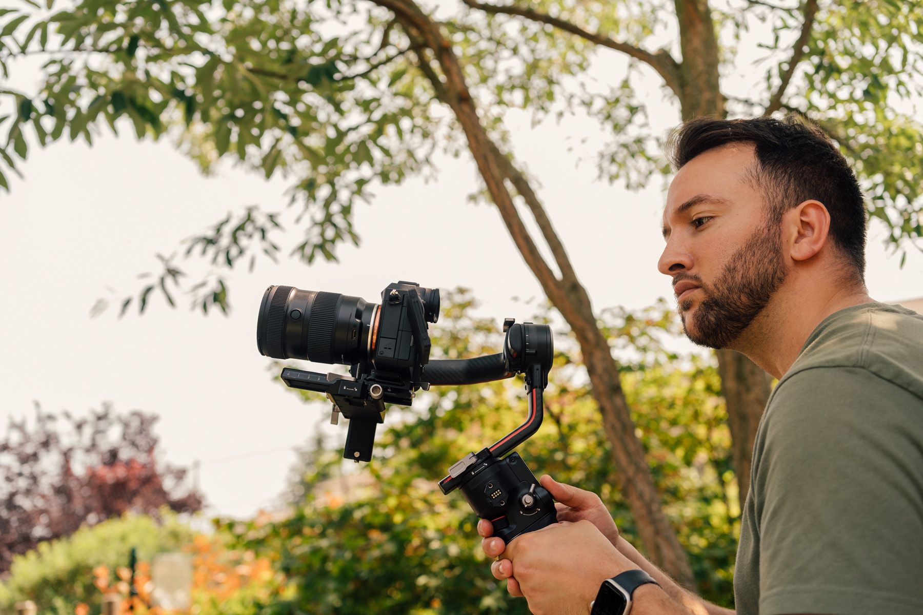 Tamron 17-50mm Lens attached to a gimbal with a photographer shooting outside in woodland