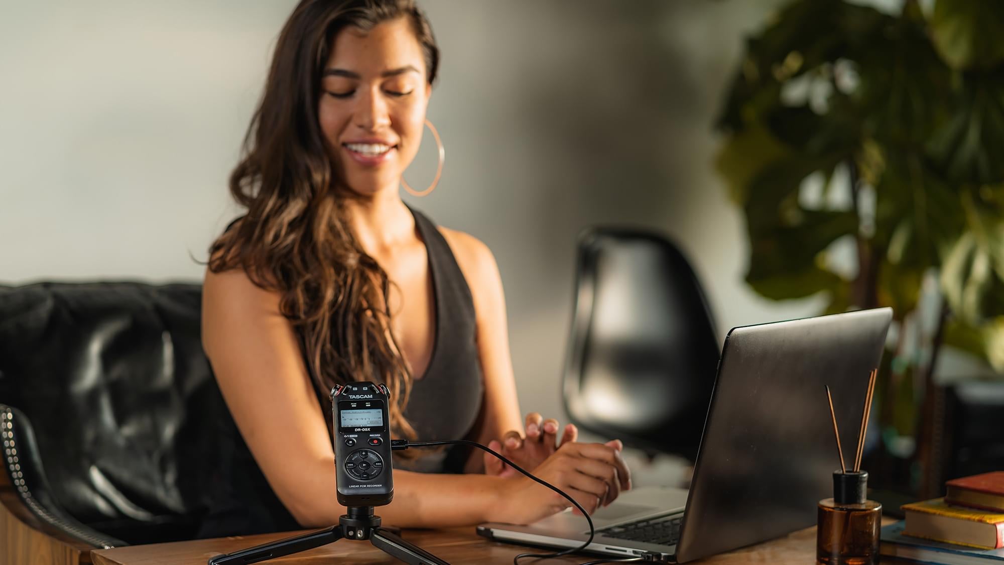 Lifestyle shot of a lady in an office using the Tascam DR-05X