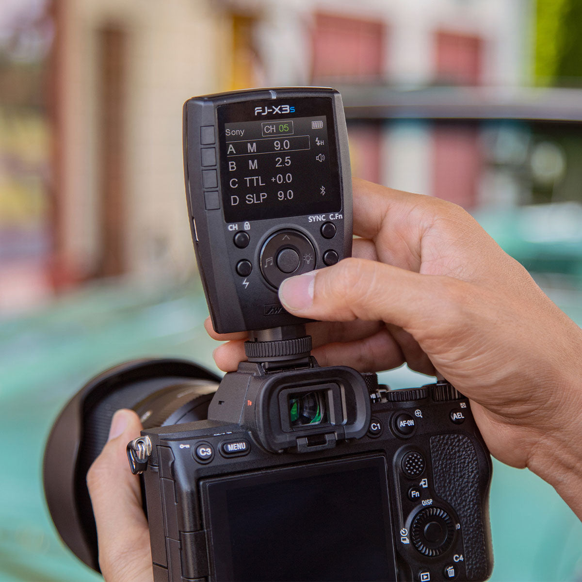 Photographer using the Westcott FJ-X3 trigger on a camera